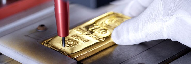 Close-up image of putting the text onto a ABC Bullion gold bar