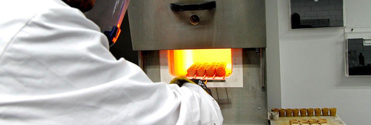 A team member works on the assaying process