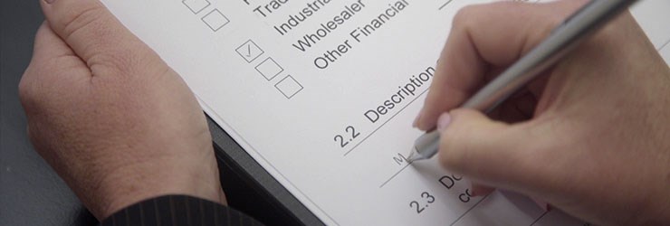 Person filling out an identification form to comply with ABC Refinery's review process